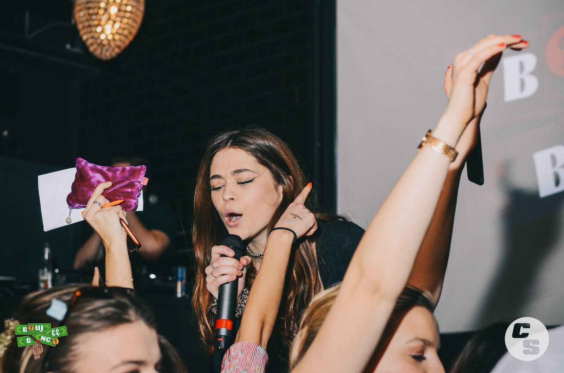 Image may contain: Leisure Activities, Finger, Microphone, Electrical Device, Night Club, Club, Night Life, Person, Human