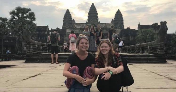 Image may contain: People, Smile, Female, Temple, Denim, Jeans, Face, Tourist, Building, Architecture, Pants, Apparel, Clothing, Vacation, Person, Human
