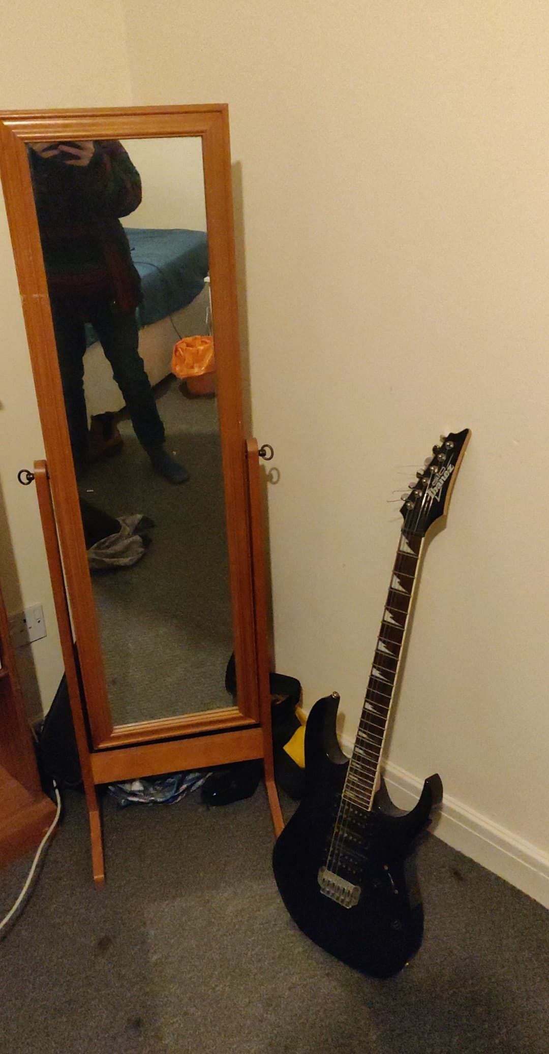 Image may contain: Bass Guitar, Interior Design, Indoors, Person, Human, Musical Instrument, Leisure Activities, Guitar