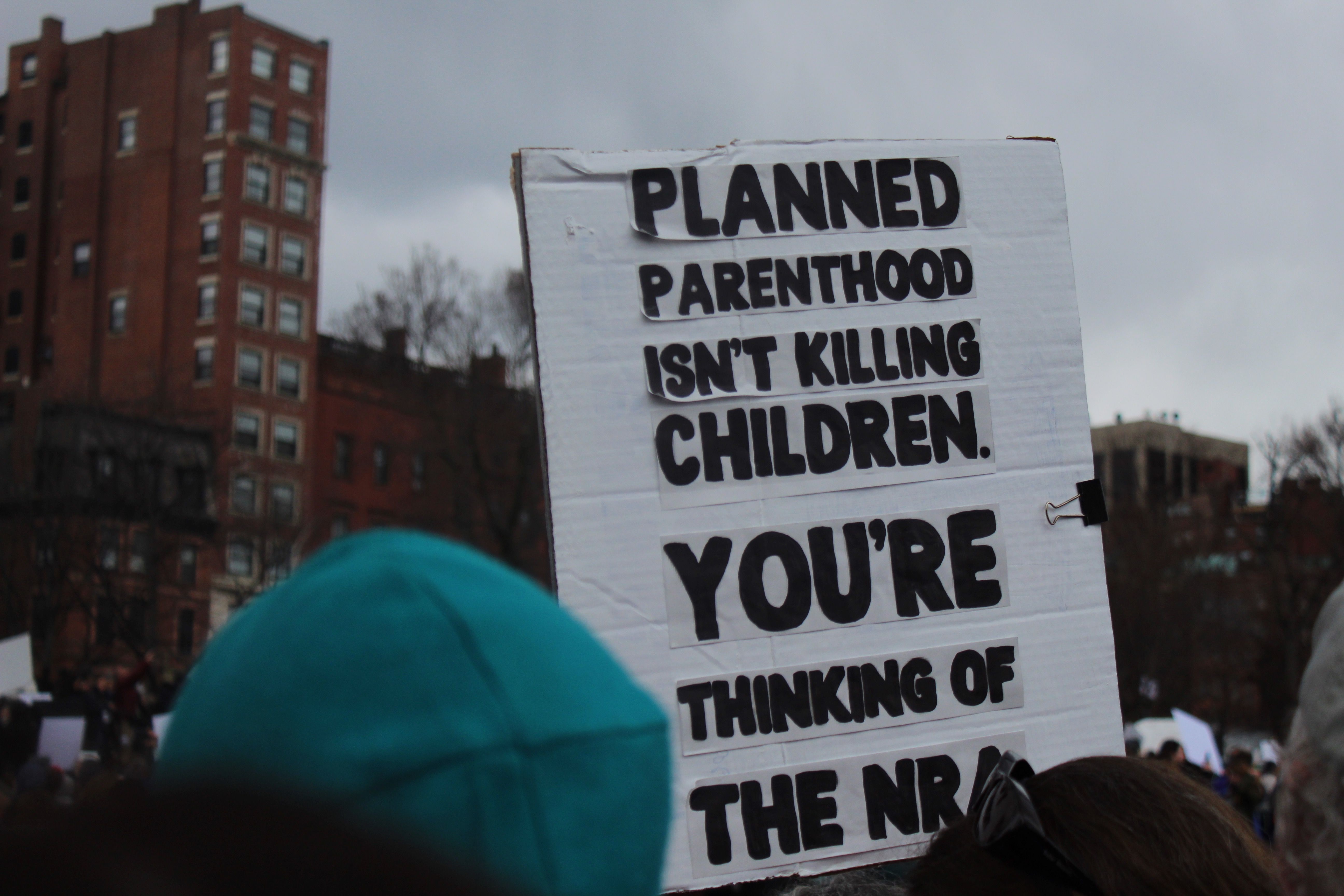Image may contain: Text, Banner, Person, Human, Crowd