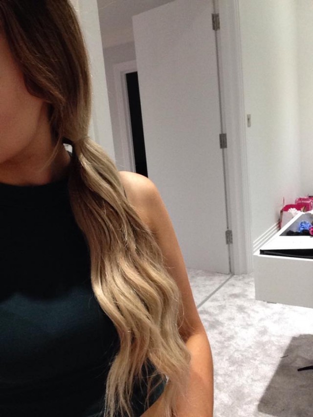 Bring hair to desired side and tie with a hairband.