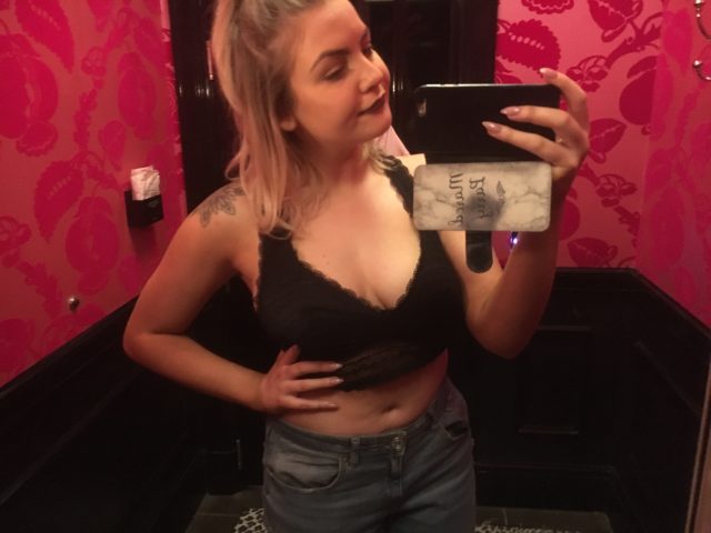 The author wearing a lace black Victoria's Secret bralette size L
