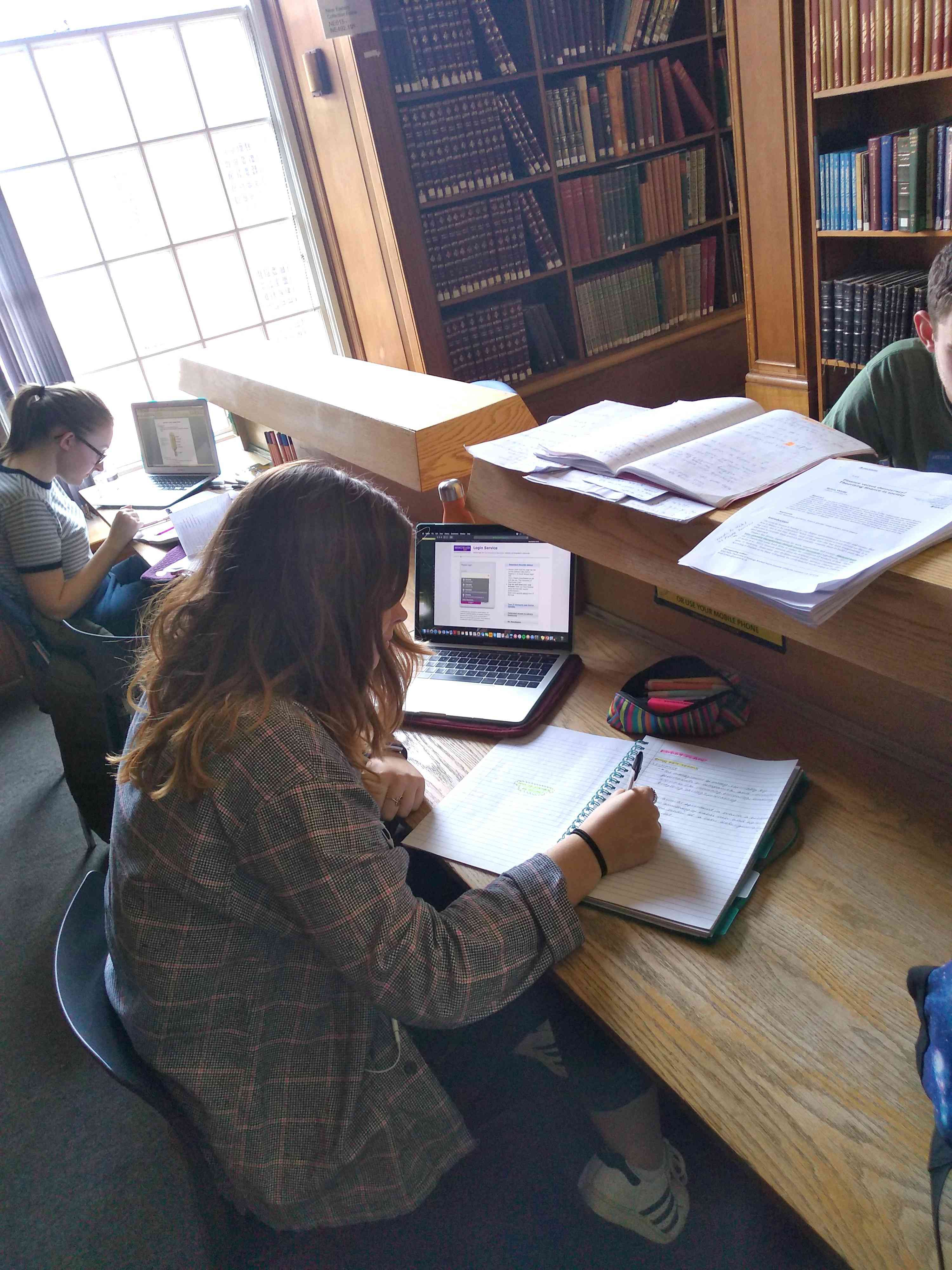 university of manchester students working in a library