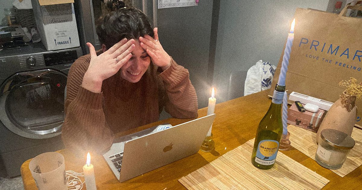 a student looking stressed by a computer by a candle and a washing machine idk why