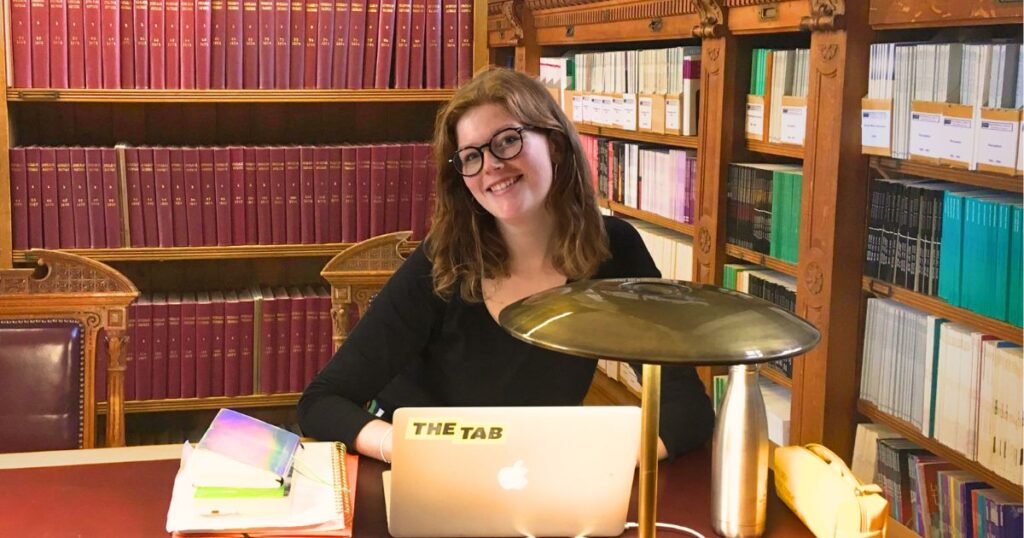 a uk uni student studying some subject in a library