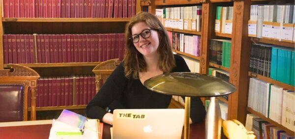 a uk uni student studying some subject in a library
