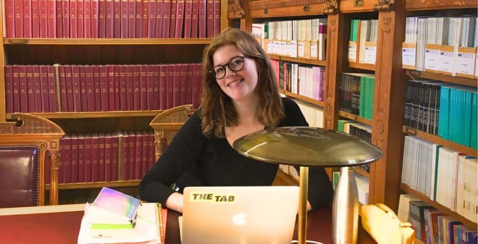 a uk uni student studying some subject in a library