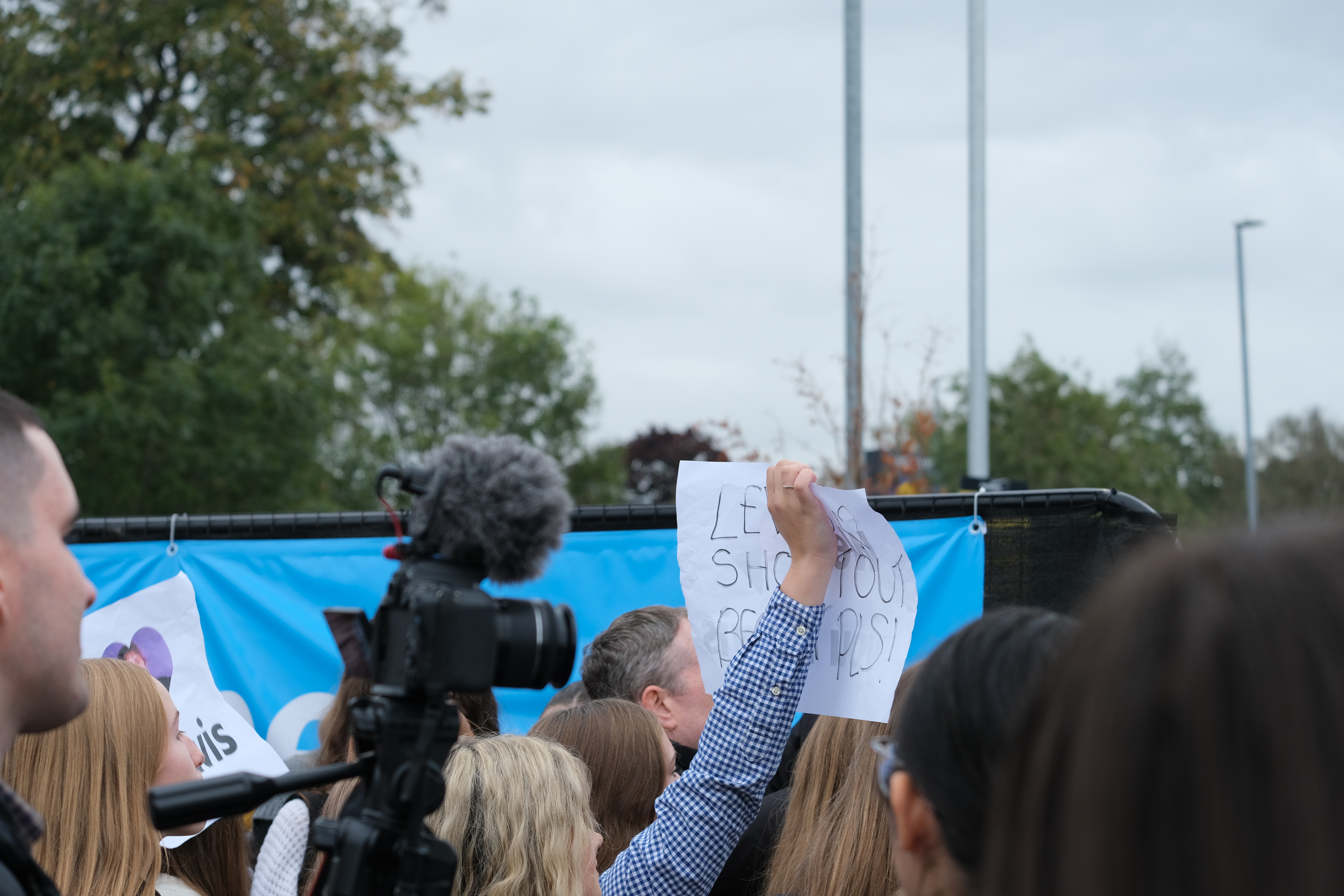 People holding signs as Lewis took to the roof of Nottingham's Aldi