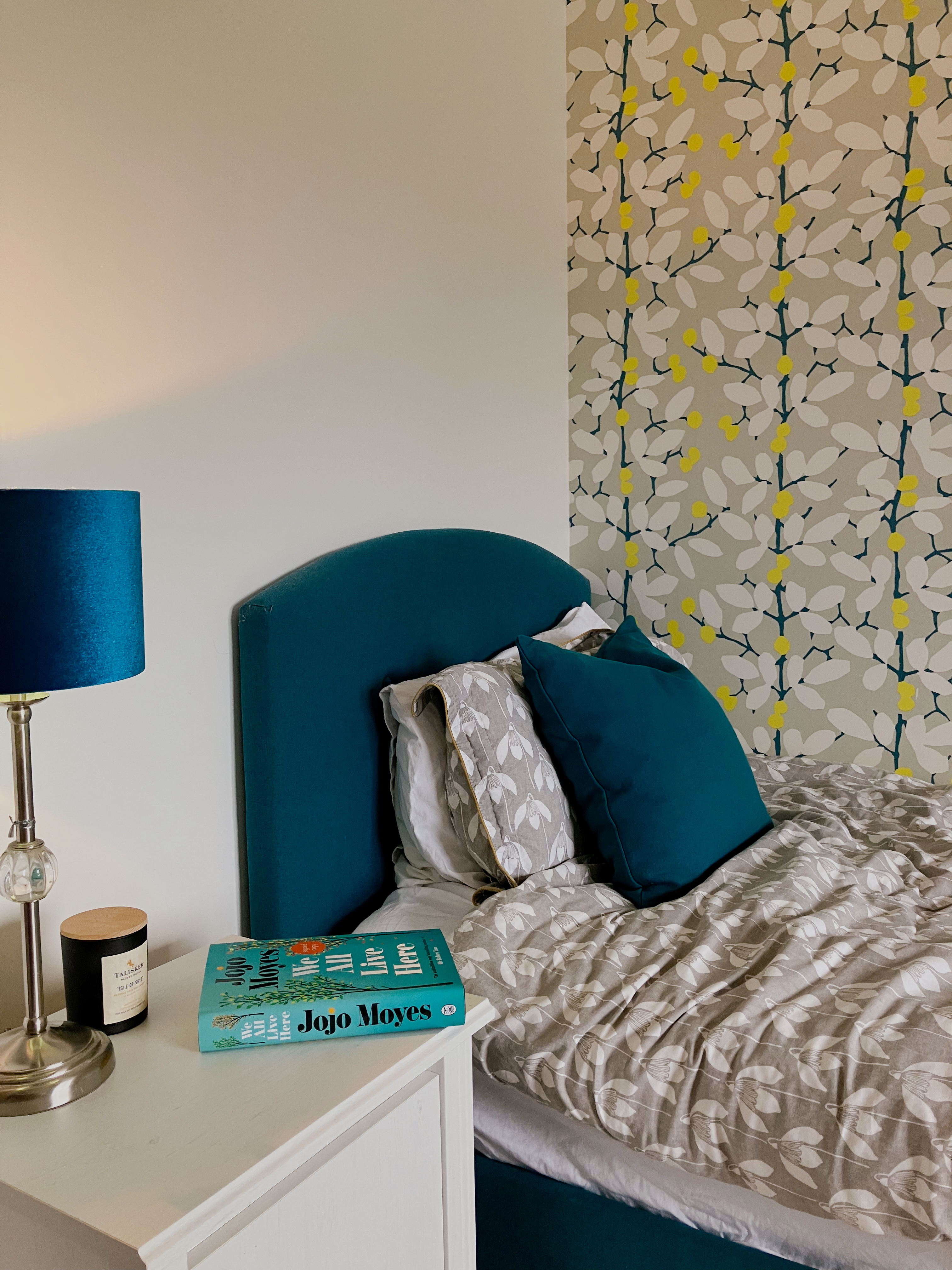A made bed and bedside table, after TikTok's 5-4-3-2-1 sleep hack made it easy to drift off 