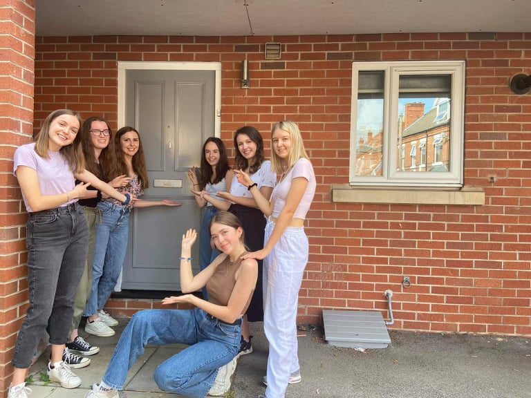 uk uni students by a house