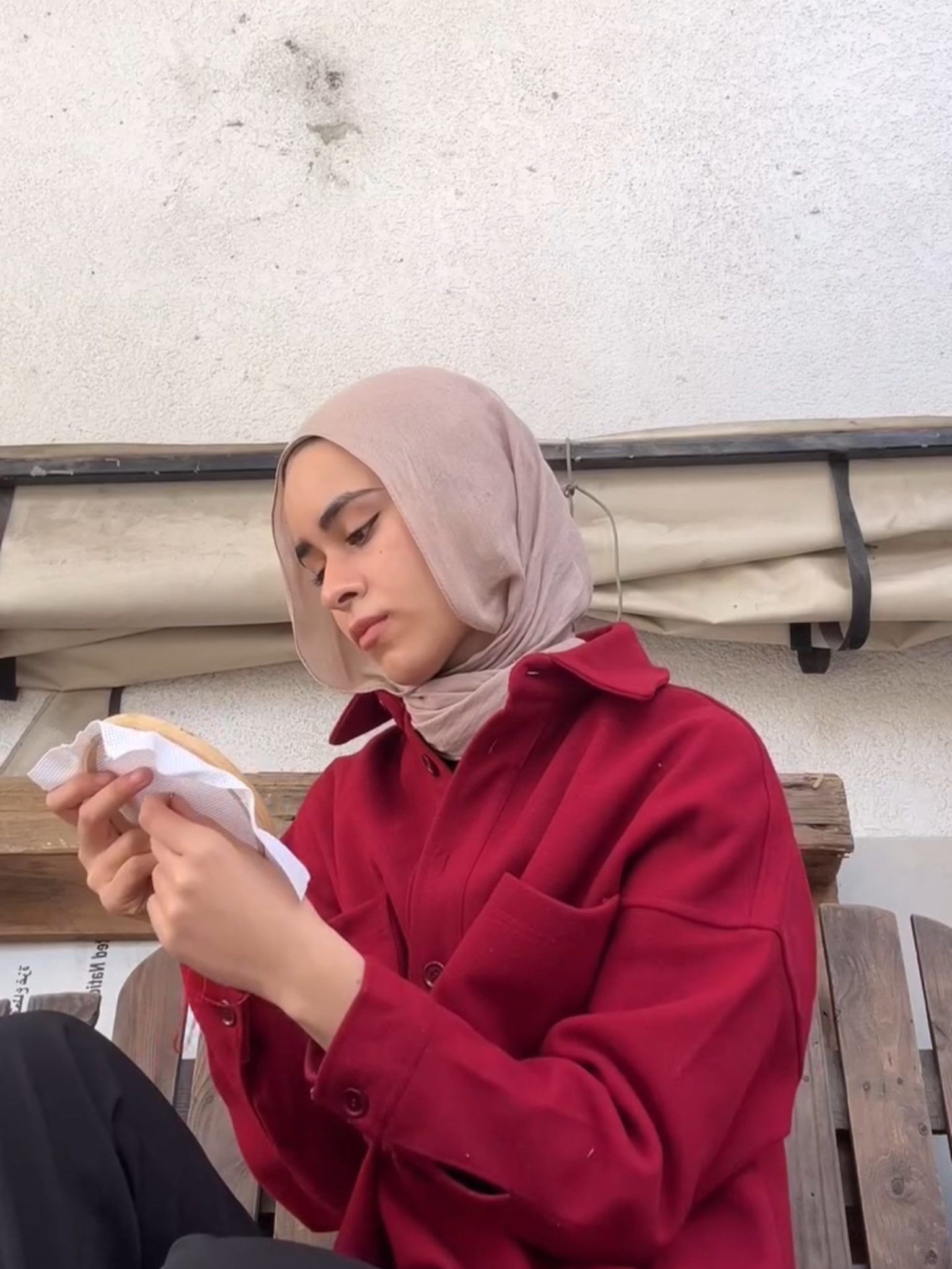 Yara practicing her hobby of tatreez in Gaza