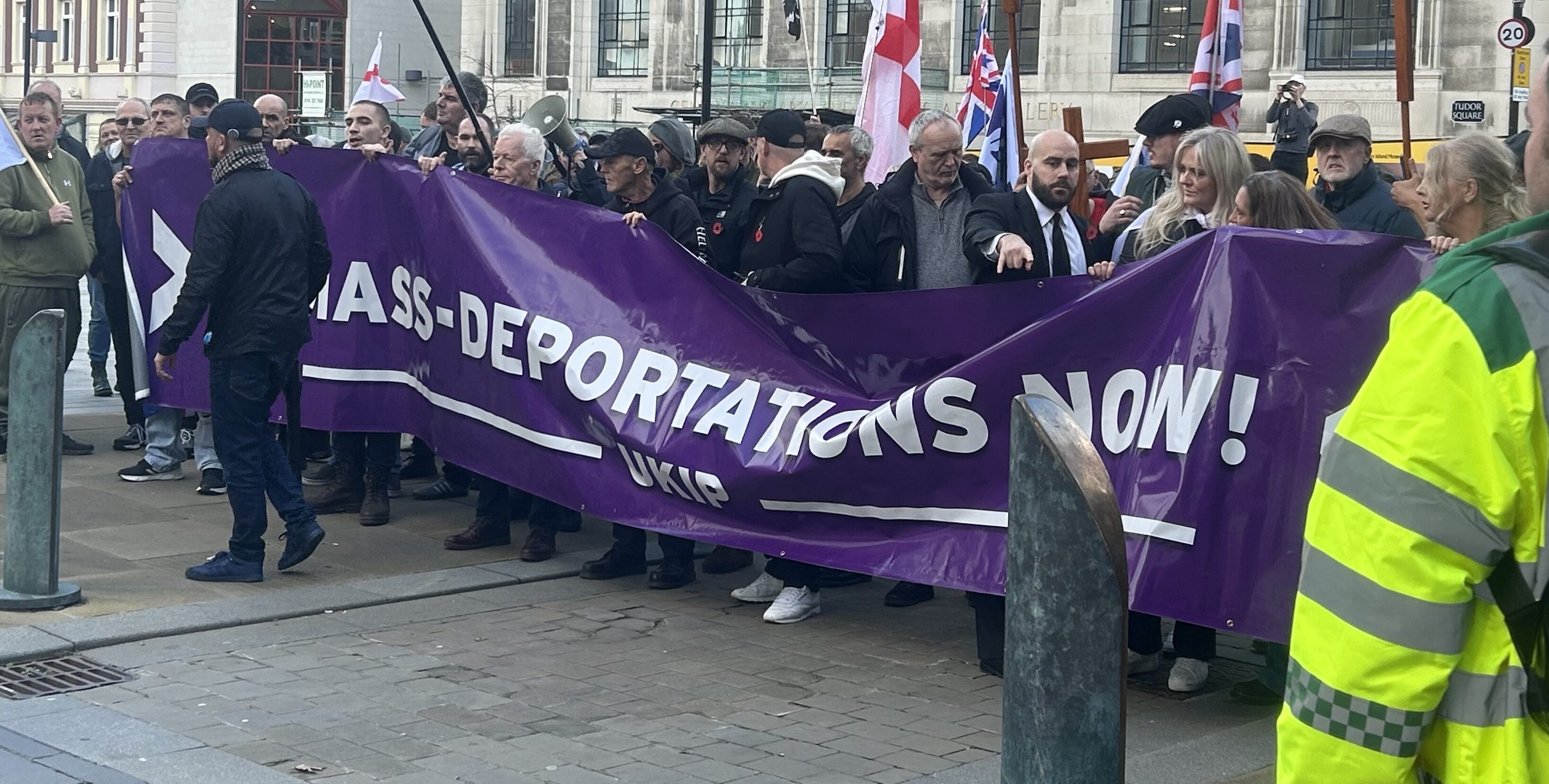 UKIP supporters at Sheffield rally holding a purple banner reading "Mass Deportations Now"UKIP supporters at Sheffield rally holding a purple banner reading "Mass Deportations Now"