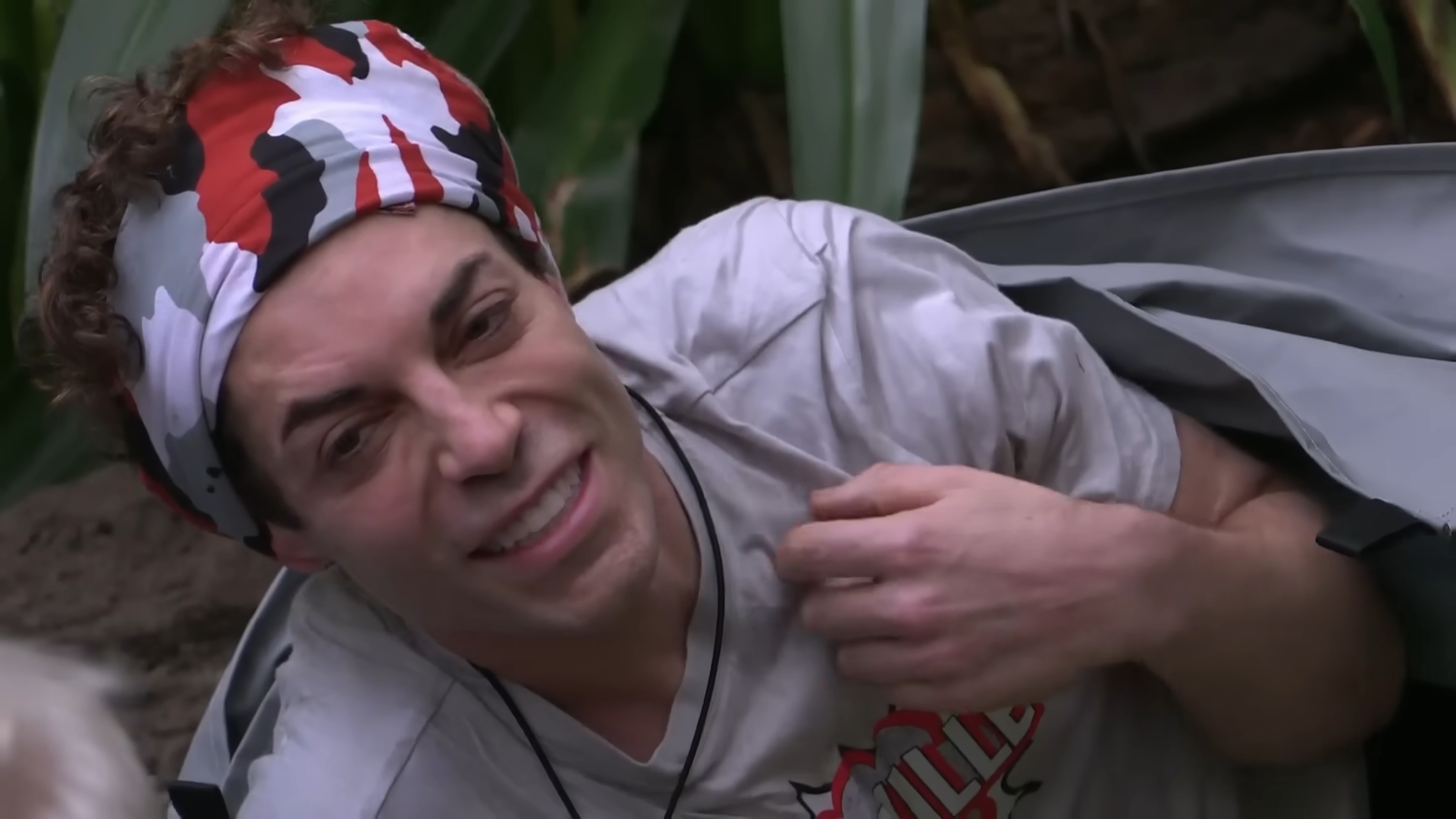 Tom trying to stay cheerful in the I'm A Celeb jungle(Image via ITV)