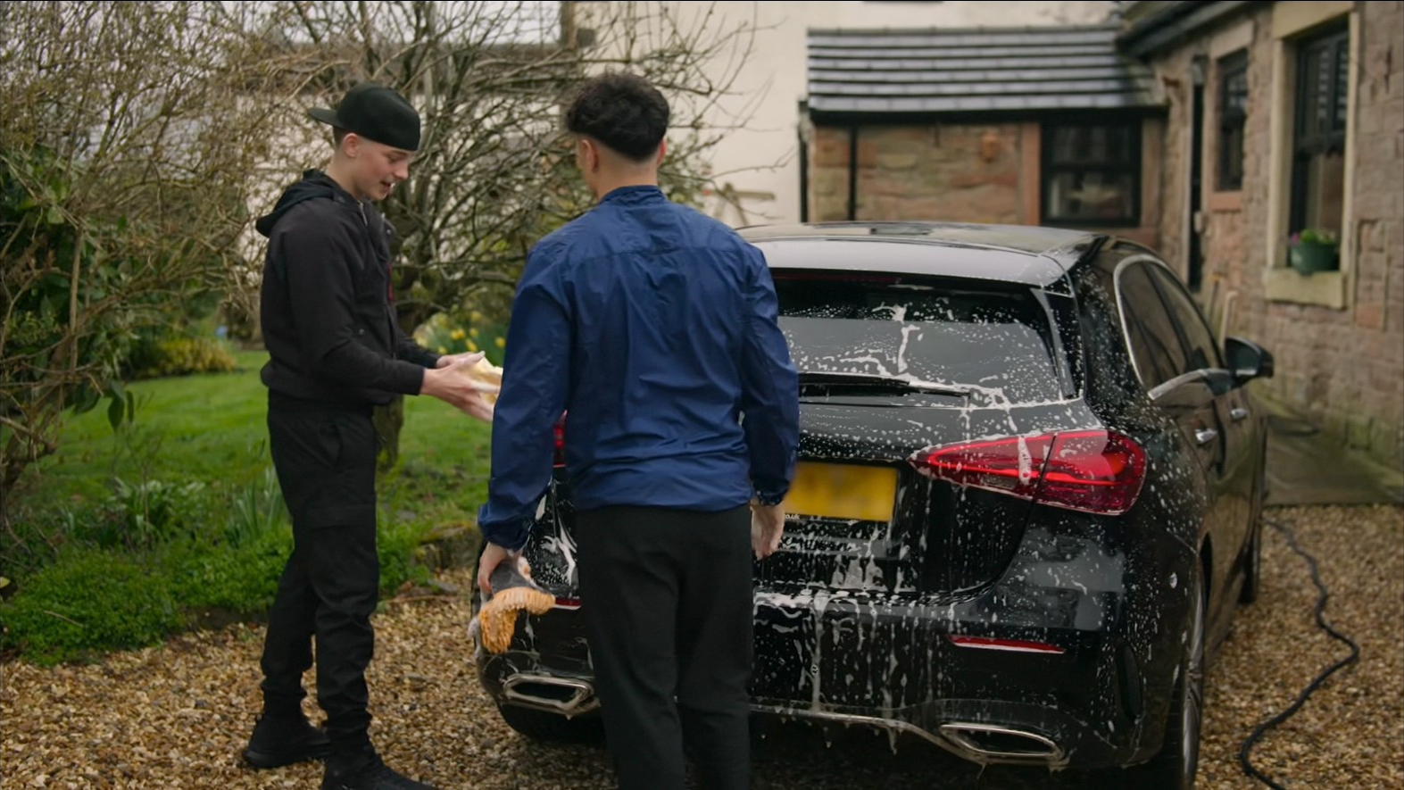 Danny and Josh washing a car together on the Netflix show for... some reason