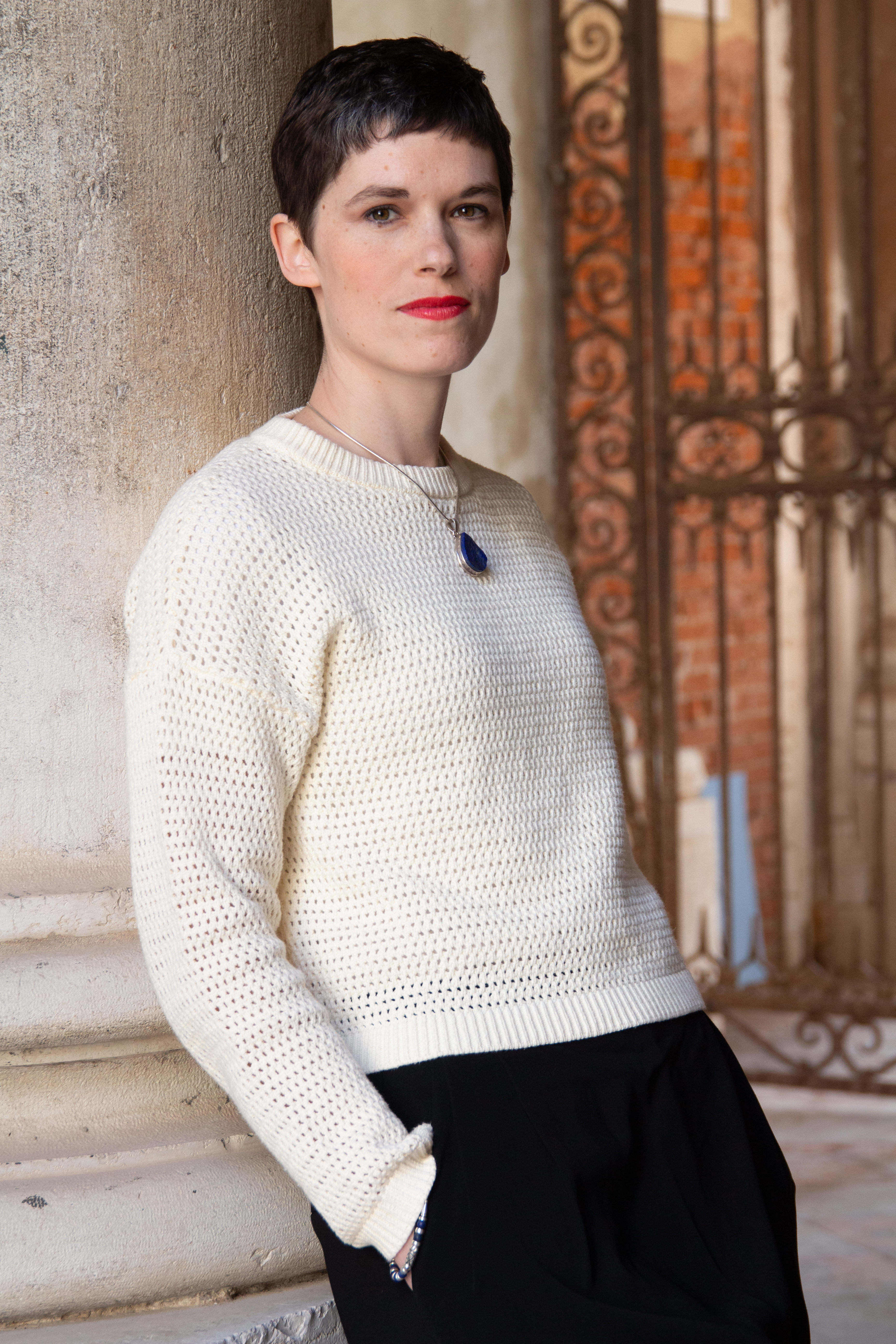 Woman (Kim Sherwood) leaning on a pillar